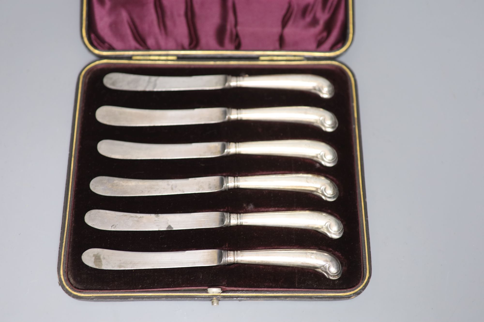 Seven assorted cased sets of silver handled tea knives including pistol handled.